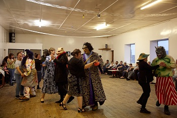 Okalolies dancing with women in Prince Philip Hall