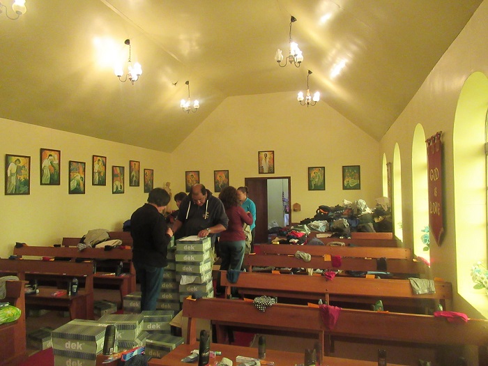 The Tristan community sorting donated clothing, shoes and toiletries in St Joseph's Church