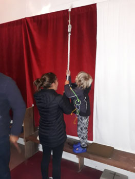 Jade Repetto helping Charlie Squibb ring the tower bell from inside St Mary's Church