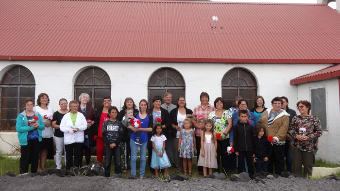 Women and children outside St Joseph's Church with James Glass, who led the Catholic service.