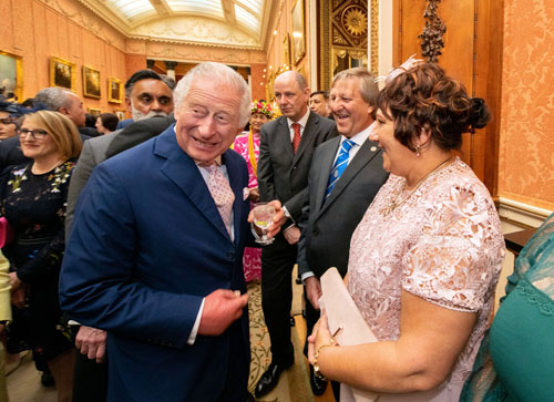 King Charles III enjoys a joke with former Tristan da Cunha Chief Islander James Glass and his wife Felicity during a Coronation Reception in Buckingham Palace on 5th May 2023 prior to his coronation the following day.