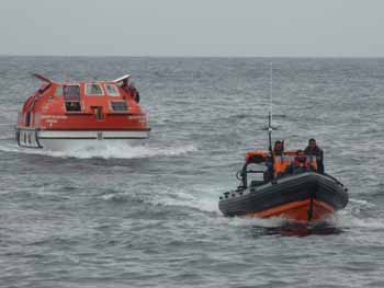 Tristan's Search & Rescue RIB escorts the first tender into harbour.
