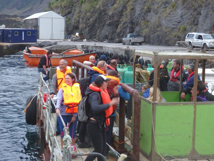 Passengers leaving Calshot Harbour on a raft for MFV Edinburgh's return voyage.
