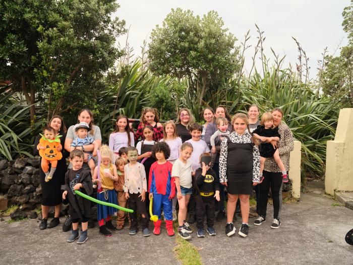 The children in their Halloween costumes with their mums.