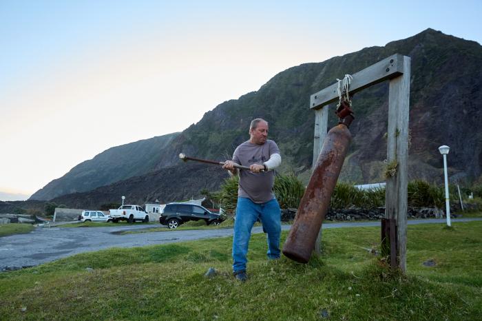 Ian Lavarello starts King's Day by ringing the Fishing Dong.
