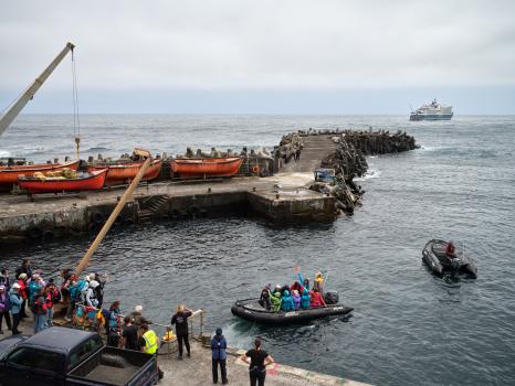 Reembarking passengers wave as they pull away from the harbour steps (Photo: Julia Gunther)