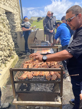 Larry Swain seasoning the meat on the braai