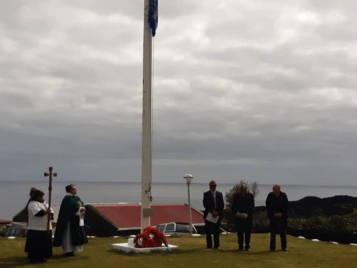 The Chief Islander and Administrator lay wreaths at the flagpole memorial.