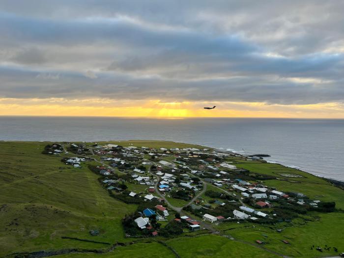 An RAF aircraft flying low over the settlement, photographed by Odile Cesari from the 1961 volcano. This is an unprecedented sight, as the rare planes that fly over Tristan do so at high altitude and are often hidden from view by the island's low clouds.