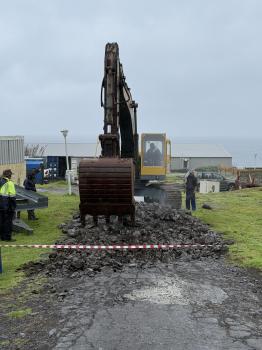 Digging up the old, damaged road surface