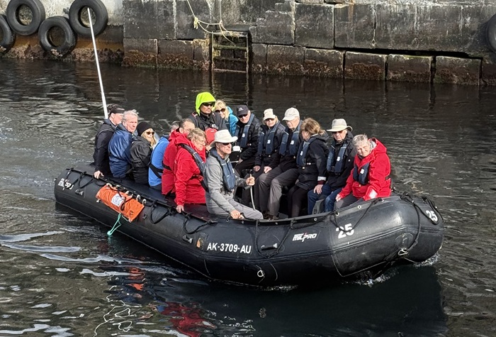 Passengers arriving by zodiac in the harbour. Photo: Philp Kendall