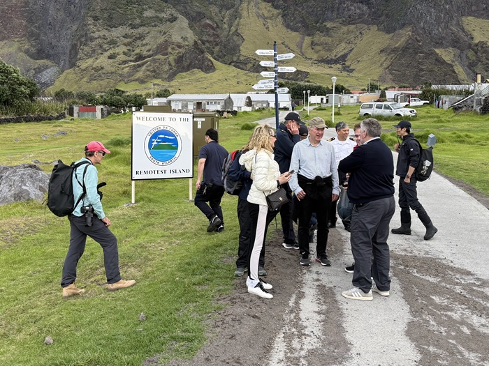 Walkers gathered by the Remotest Island signs. Photo: Philip Kendall