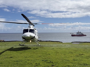 The helicopter lifting of to return the the ship.