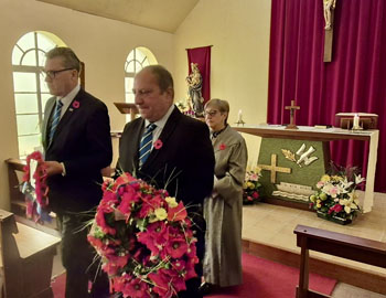 Chief Islander Ian Lavarello, with the community wreath and Administrator Philip Kendall with the Government wreath, process fromn the Church at the end of the service.