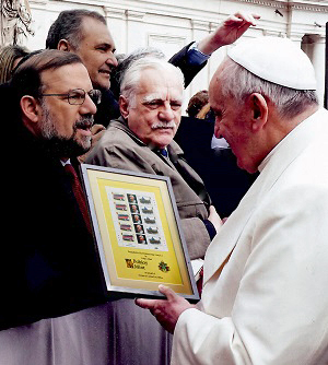 Pope Francis admires a framed sheet of Tristan da Cunha stamps that was presented to him during a public audience in the Vatican City