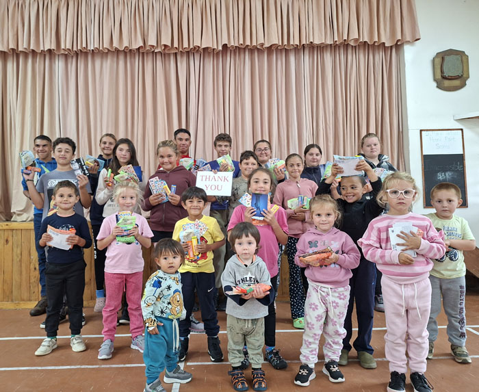 The children with their presents from Mandy and Noel
      during a St Mary's School assembly on 31st March.