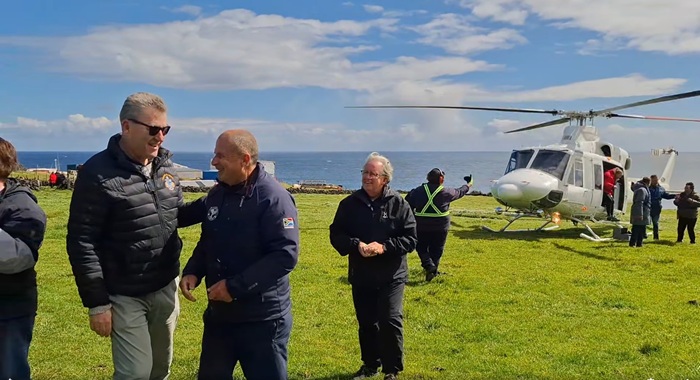 Administrator Philip Kendall greeting passengers as they emerge from the helicopter.