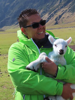 Paula cradling a lamb