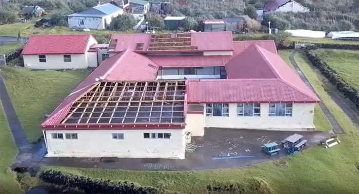 Aerial view from the east of the storm damage to St Mary's School, Tristan da Cunha