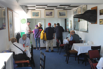 Thirsty and hungry visitors buy Albatross Ale and refreshments at the Post Office and Tourism Café counter 