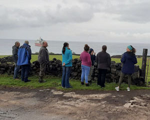 Islanders watching the helicopter ferry passengers between the Agulhas II and American Fence
