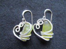 TT31 - Sterling silver earrings containing small beach stone or seaglass, 3cm drop